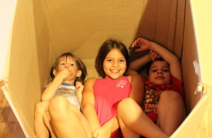 children playing in cardboard box