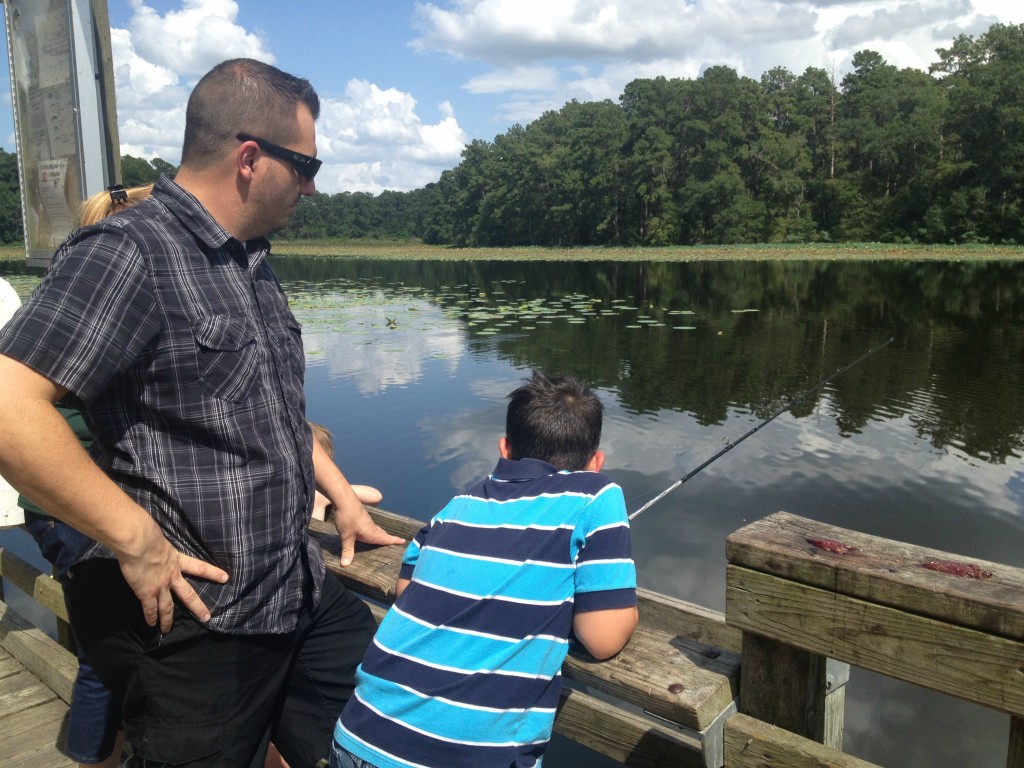 boy and father fishing on a pier