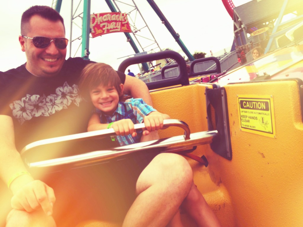 father and son on amusement park ride
