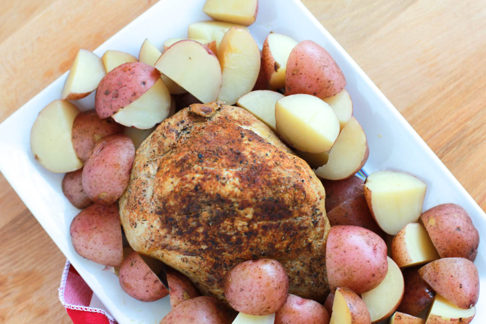 A beautiful array of Slow Cooker Pork Sirloin Tip Roast with Red Potatoes on a plate