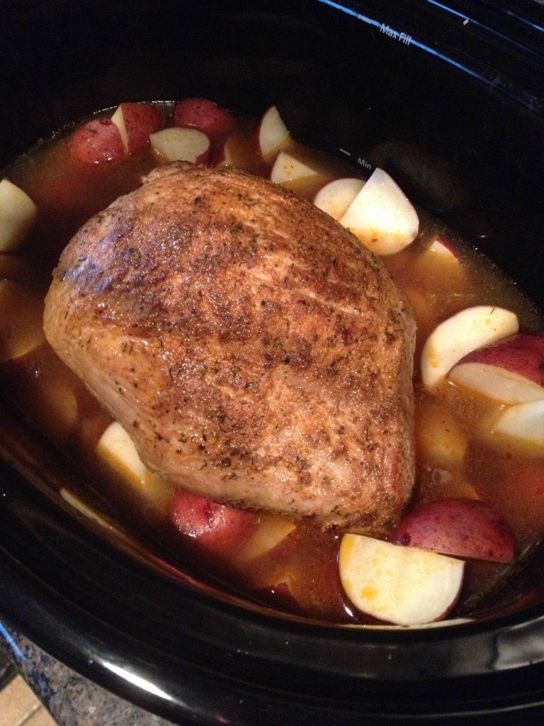 A beautiful array of Slow Cooker Pork Sirloin Tip Roast with Red Potatoes on a plate