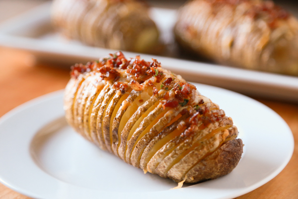 Hasselback Potatoes are a household favorite. Take yours to the next level by adding some bacon and cheese to create these Bacon & Cheese Hasselback Potatoes.