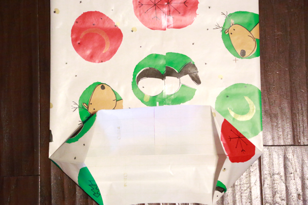 Need to wrap an odd-shaped present and don't have a gift bag at home. Make your own DIY Gift Bag from wrapping paper with this easy to follow tutorial.