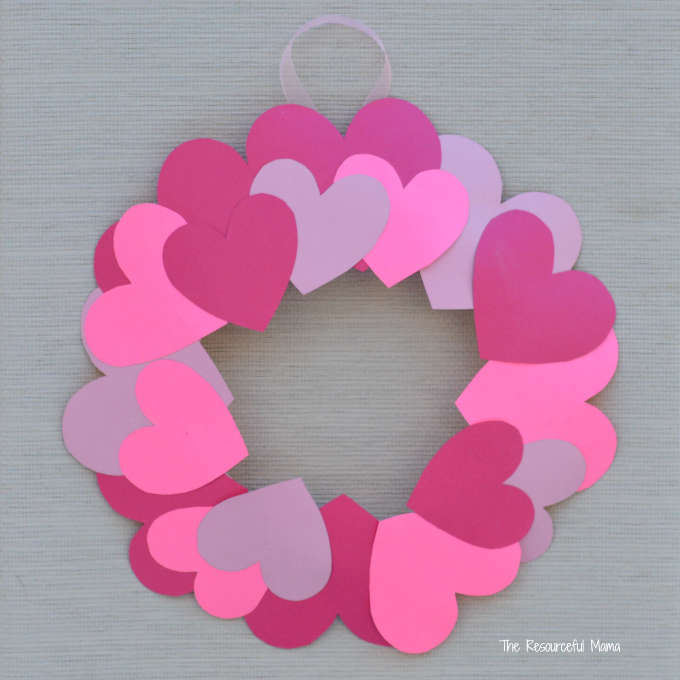 a heart wreath made with many different colored paper hearts