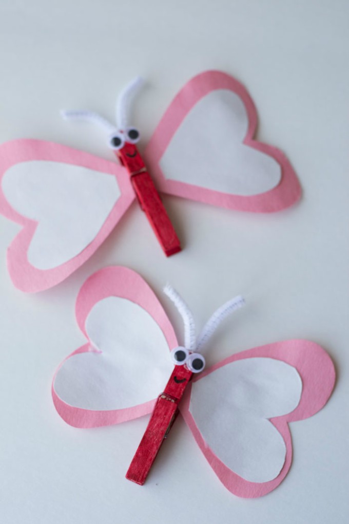 a butterfly made with construction paper hearts with clothespins