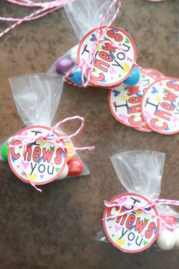 A bunch of bags of gum balls with the I Chews You printable tied on top