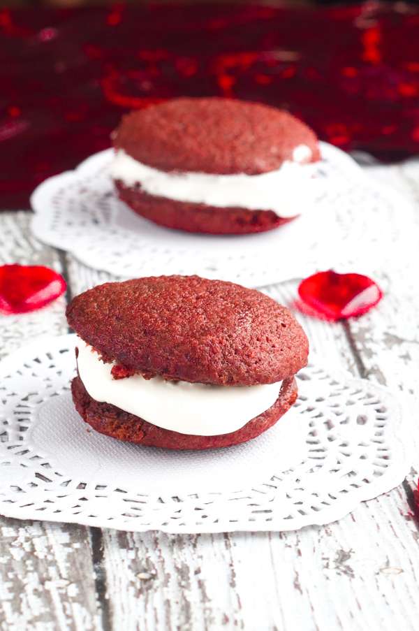 Nothing says Happy Valentine's Day like these Red Velvet Mini Whoopie Pies with Marshmallow Cream Cheese Frosting right in the middle. So yummy!