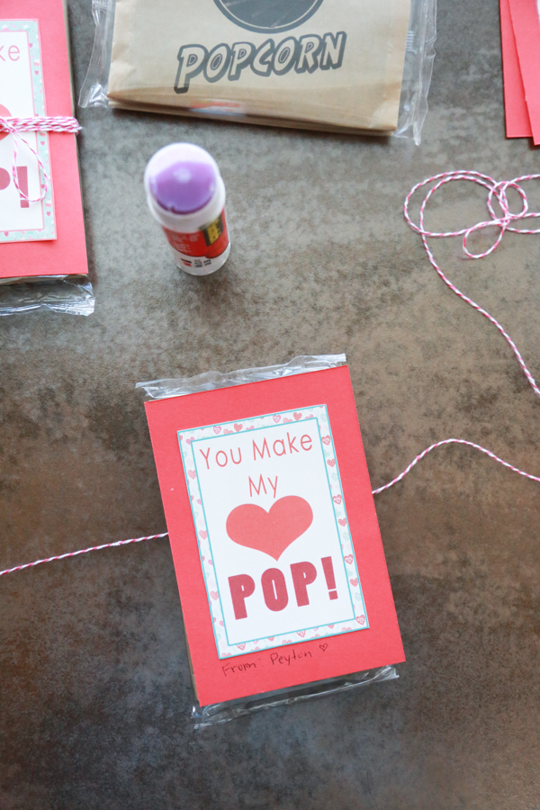 You Make My Heart Pop Valentines printable tied around an unpopped bag of popcorn!