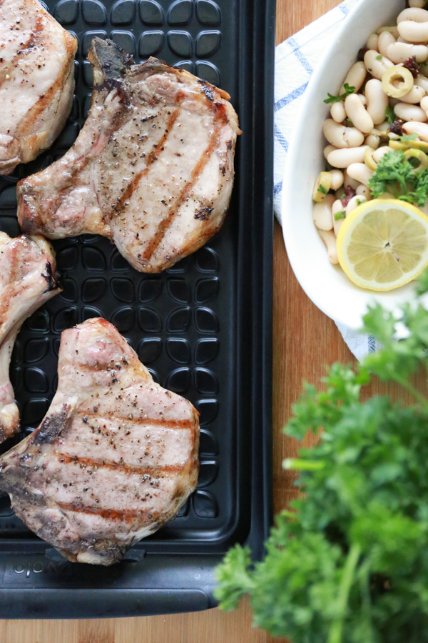 Fire up the grill and make these delicious Grilled Pork Chops with Tuscan Bean Salad.