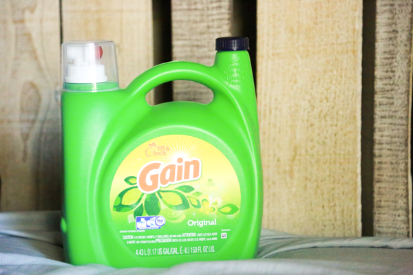 a bottle of gain on a bed