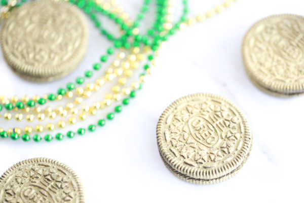 lots of edible gold oreos with gold and green bead necklaces