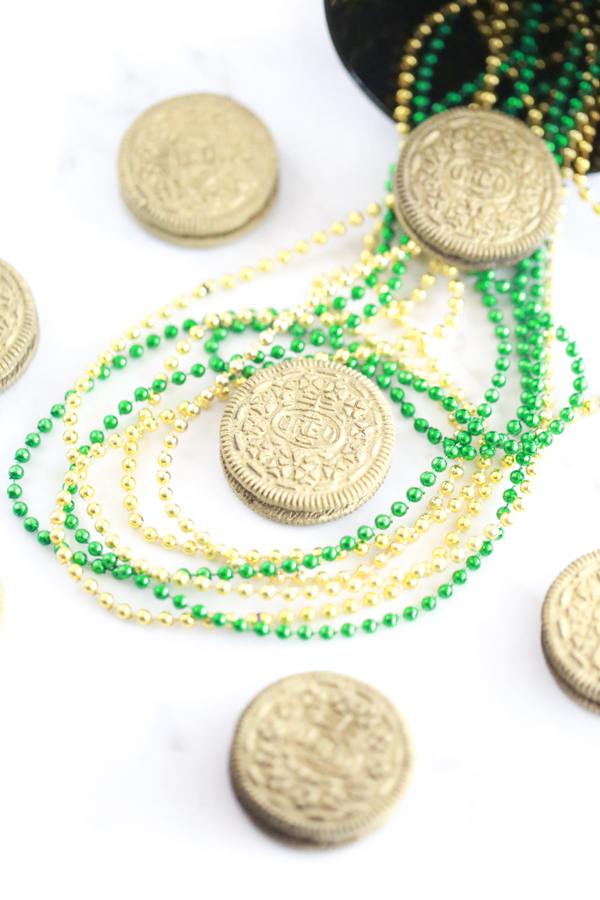 lots of edible gold oreos with gold and green bead necklaces