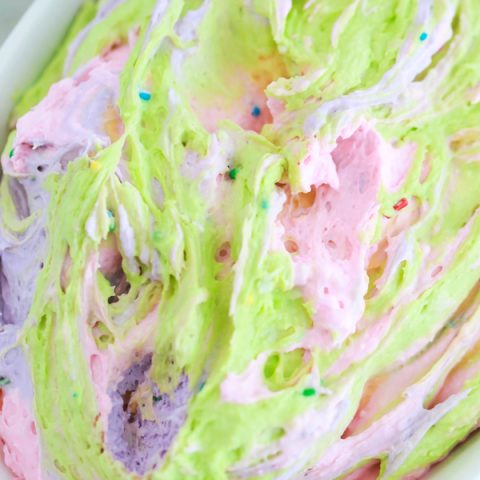 a bowl full of colorful dip for dipping animal crackers