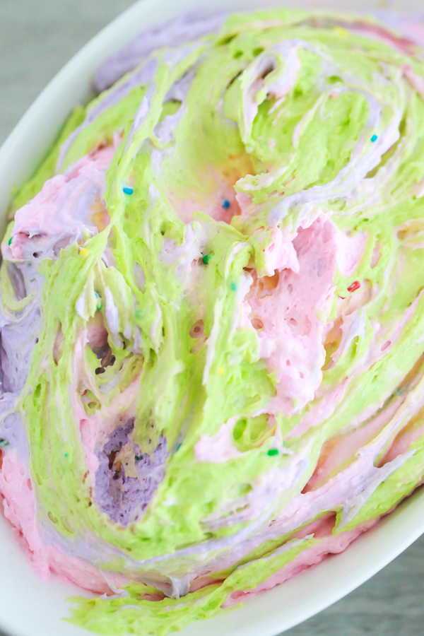 a bowl full of colorful dip for dipping animal crackers