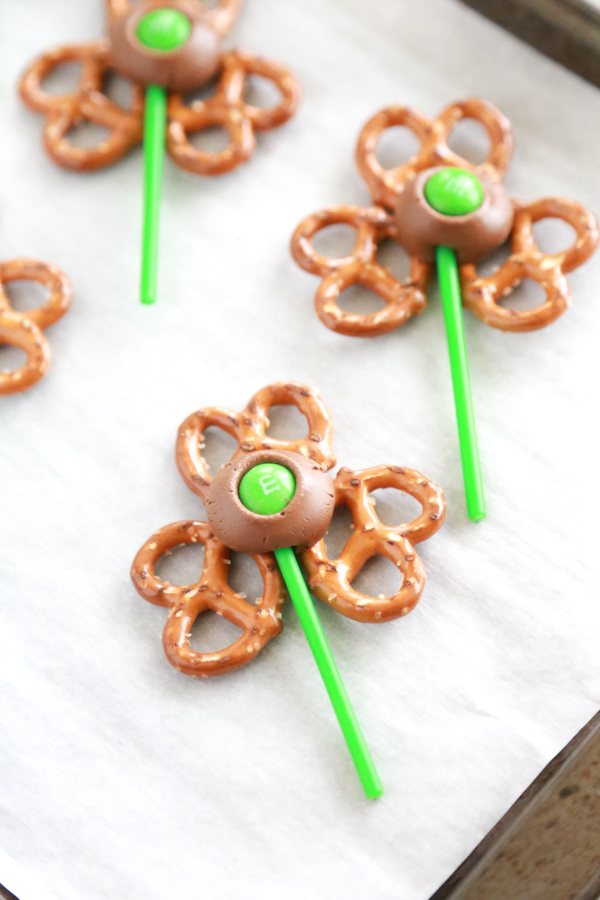 pretzel twists shaped into a shamrock or 3-leaf clover topped with a Rolo chocolate/caramel candy