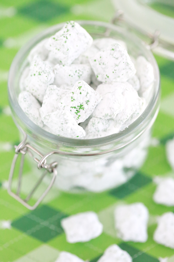 st. patrick's day puppy chow - rice chex mix covered in green candy melts, powdered sugar, and green sugar sprinkles