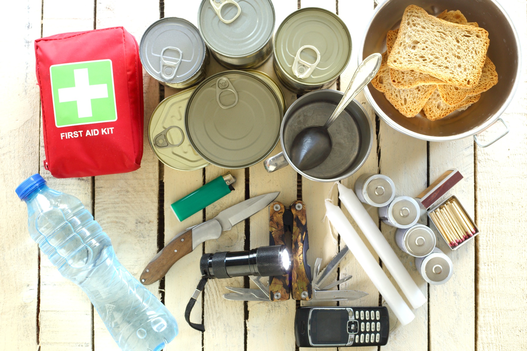 a bunch of items for a hurricane emergency on a wooden table