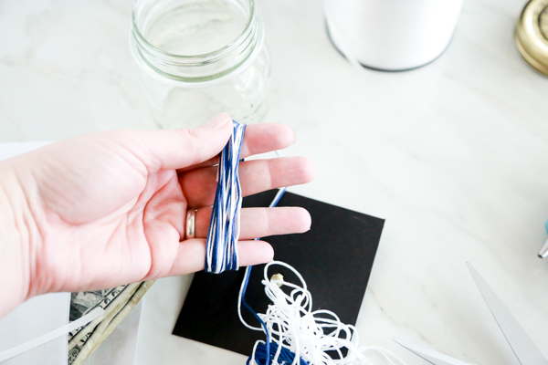 Surprise the deserving graduate with this adorable Mason Jar Graduation Hat Gift Idea filled with dollar bill diplomas.