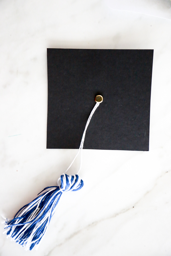 Surprise the deserving graduate with this adorable Mason Jar Graduation Hat Gift Idea filled with dollar bill diplomas.