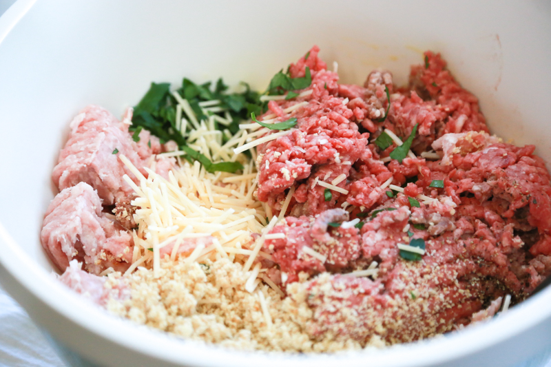 a bowl of ingredients for homemade meatballs